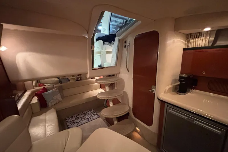 Dulce Vita Yacht Photos Pics Interior of 2003 Sea Ray 340 Sundancer yacht, featuring cozy seating and compact kitchenette.