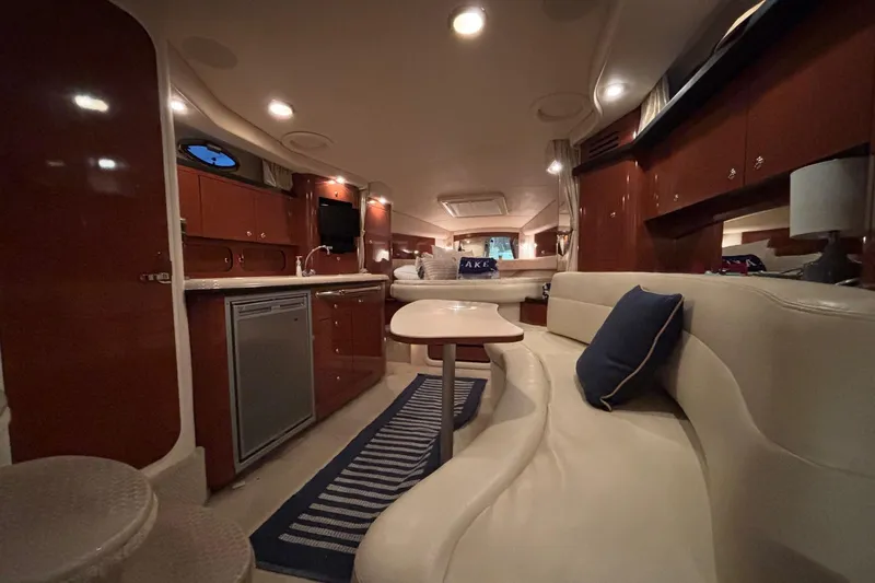 Dulce Vita Yacht Photos Pics Luxurious interior of 2003 Sea Ray 340 Sundancer yacht with elegant seating and kitchenette.