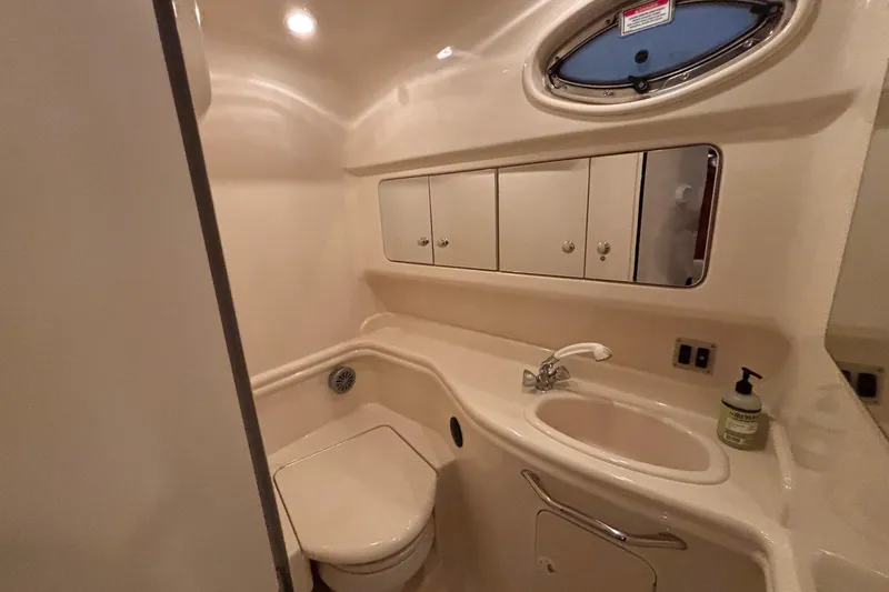 Dulce Vita Yacht Photos Pics 2003 Sea Ray 340 Sundancer bathroom with sink, toilet, and storage cabinets.