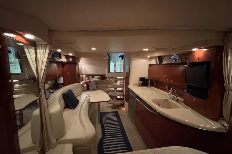 Dulce Vita Yacht Photos Pics Luxurious interior of 2003 Sea Ray 340 Sundancer yacht with elegant seating and kitchenette.