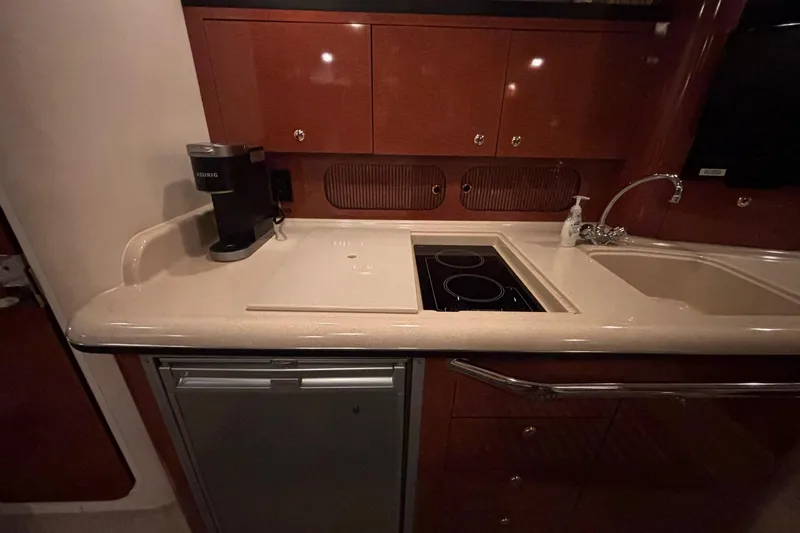 Dulce Vita Yacht Photos Pics 2003 Sea Ray 340 Sundancer kitchen with stove, sink, fridge, and coffee maker.