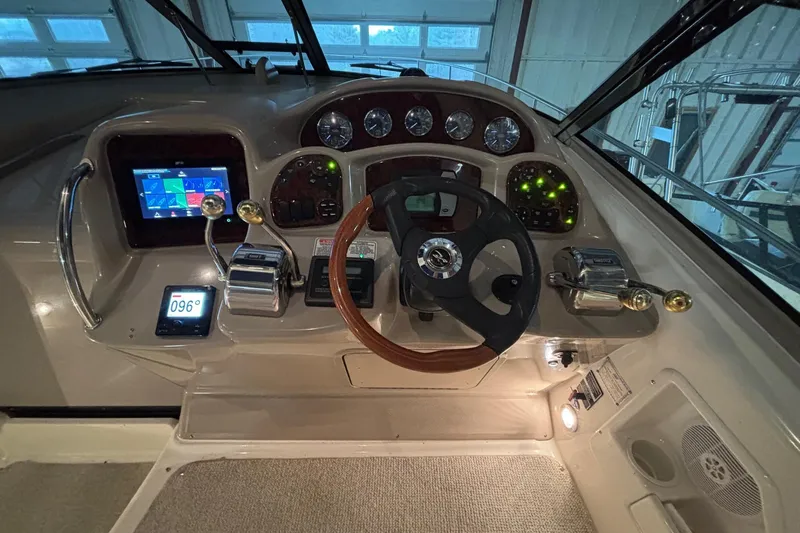 Dulce Vita Yacht Photos Pics Cockpit of 2003 Sea Ray 340 Sundancer with steering wheel and navigation controls.