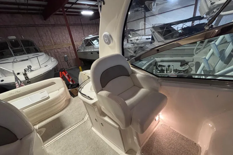 Dulce Vita Yacht Photos Pics 2003 Sea Ray 340 Sundancer interior with plush seating in a boat storage facility.