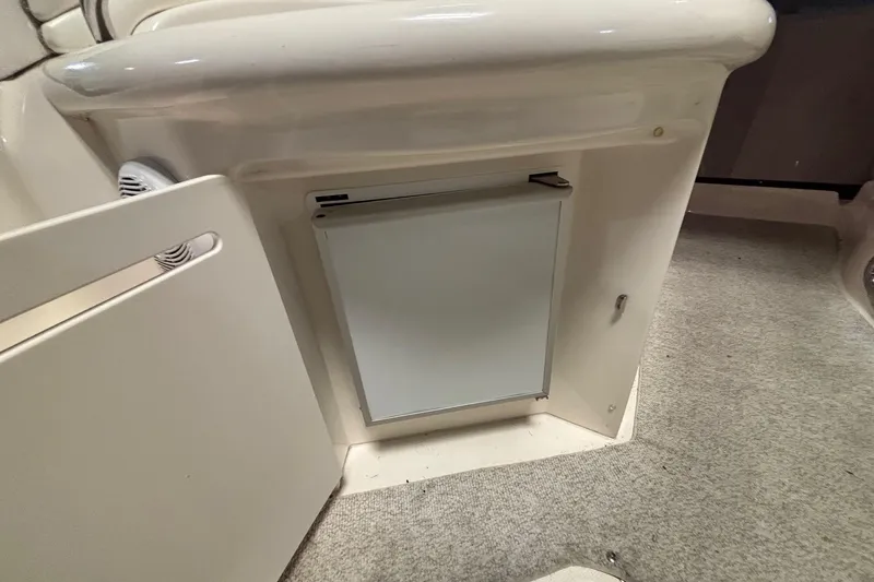 Dulce Vita Yacht Photos Pics 2003 Sea Ray 340 Sundancer interior with compact fridge and carpeted flooring.