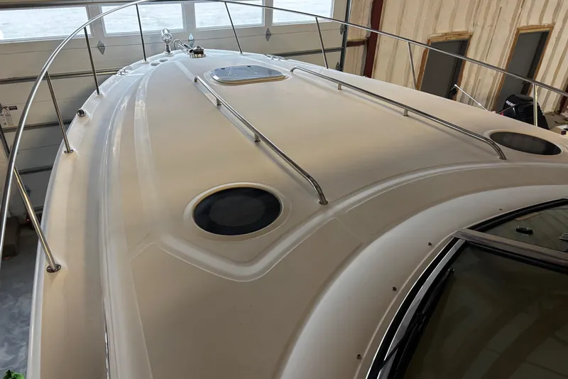 Dulce Vita Yacht Photos Pics 2003 Sea Ray 340 Sundancer boat deck with railings in a garage setting.