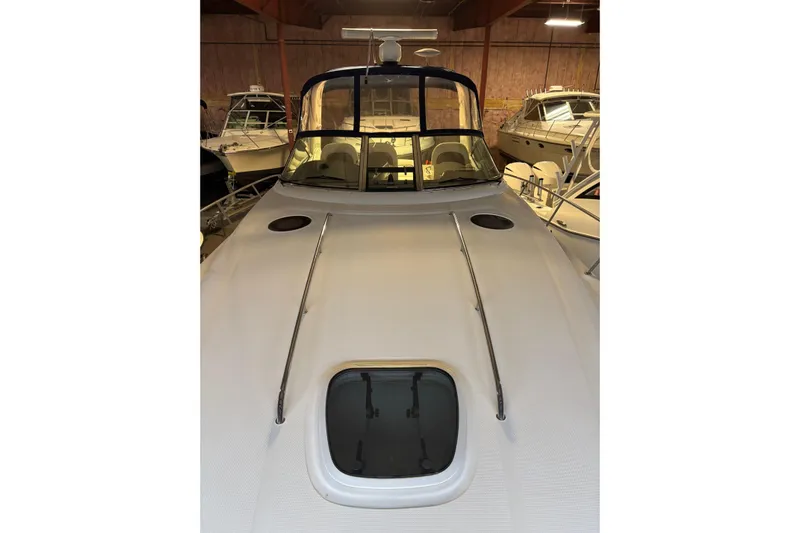 Dulce Vita Yacht Photos Pics 2003 Sea Ray 340 Sundancer yacht in storage, showcasing sleek design and spacious deck.