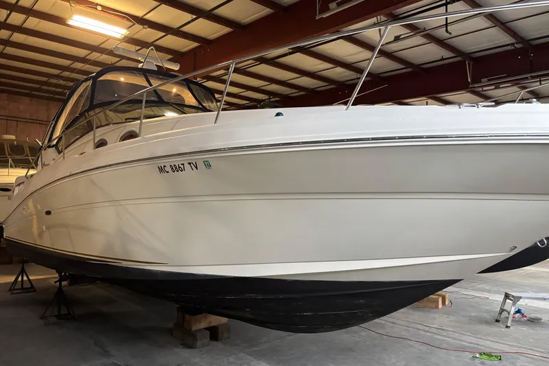 Dulce Vita Yacht Photos Pics 2003 Sea Ray 340 Sundancer boat in indoor storage, side view.