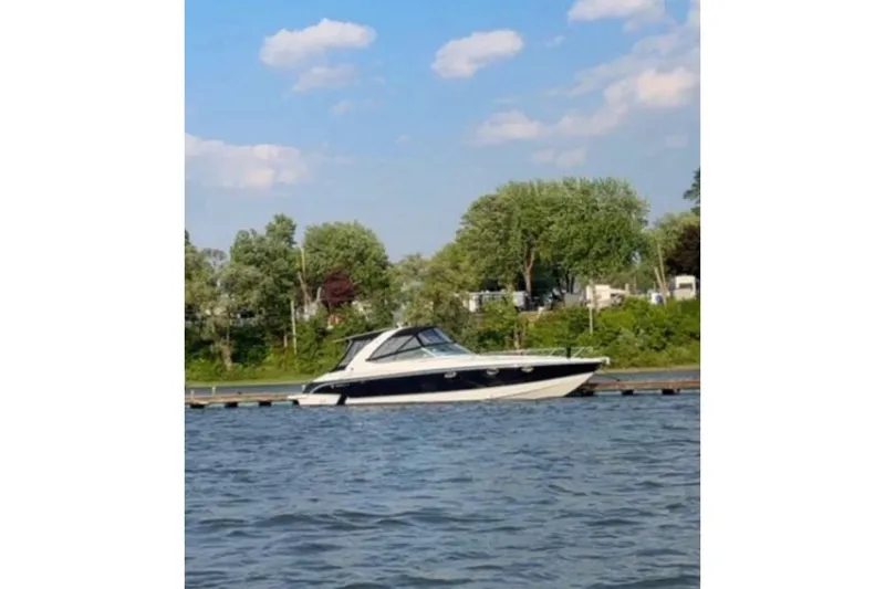  Yacht Photos Pics 2007 Formula 370 Super Sport boat docked on a calm lake with trees in the background.