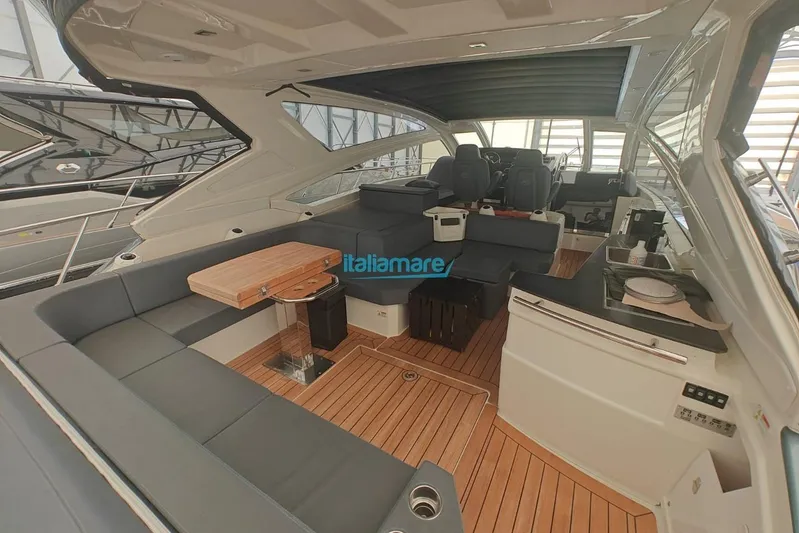  Yacht Photos Pics Luxurious interior of 2018 Cranchi 60 ST yacht with elegant seating and wooden flooring.
