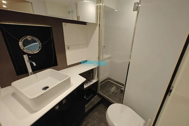  Yacht Photos Pics Modern bathroom in 2018 Cranchi 60 ST yacht with sleek fixtures and porthole window.