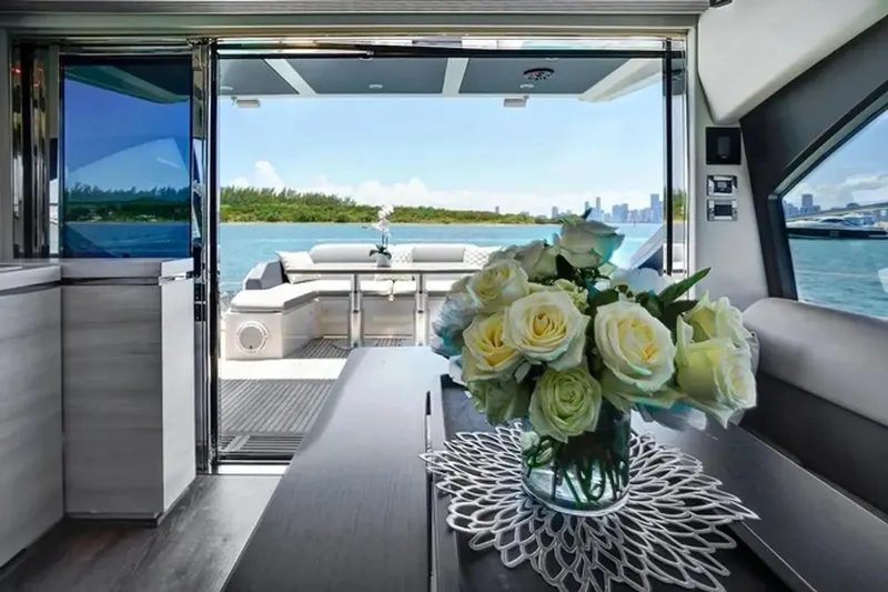 Lithium Yacht Photos Pics Luxurious interior of 2015 Azimut 55S yacht with elegant floral arrangement and scenic ocean view.