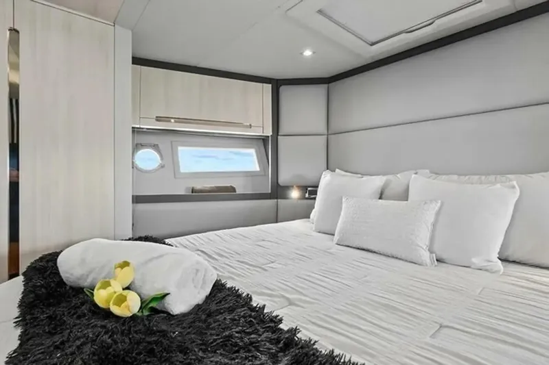 Lithium Yacht Photos Pics Luxurious bedroom interior of 2015 Azimut 55S yacht with elegant bedding and window view.