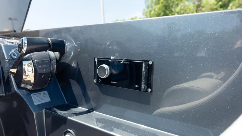 1017gt2017 Yacht Photos Pics Control panel of a 2017 Frauscher 1017 GT boat with throttle and Fusion audio system.