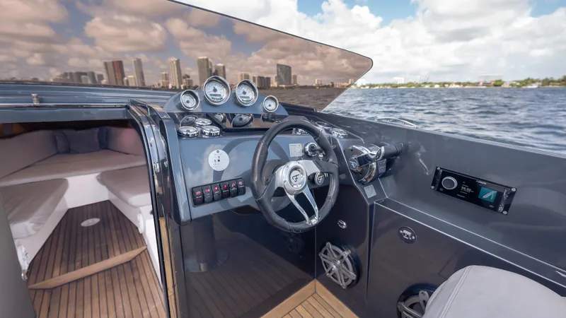 1017gt2017 Yacht Photos Pics Interior view of 2017 Frauscher 1017 GT yacht cockpit with city skyline in background.