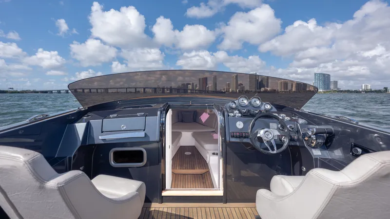 1017gt2017 Yacht Photos Pics 2017 Frauscher 1017 GT yacht cockpit with city skyline in background.