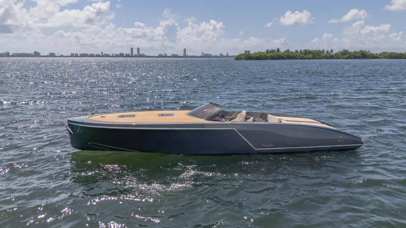 1017gt2017 Yacht Photos Pics 2017 Frauscher 1017 GT boat on calm water under a sunny sky.