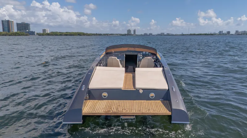 1017gt2017 Yacht Photos Pics 2017 Frauscher 1017 GT luxury boat on open water with city skyline.