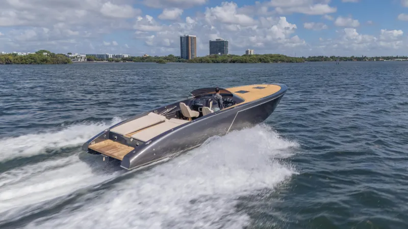 1017gt2017 Yacht Photos Pics 2017 Frauscher 1017 GT speedboat cruising on open water under a partly cloudy sky.