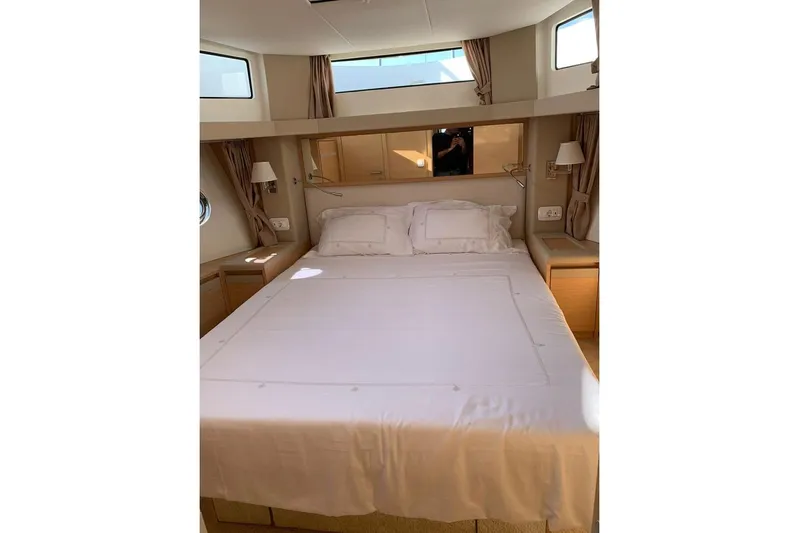  Yacht Photos Pics Luxurious bedroom interior of 2022 Greenline 45 Coupe yacht, featuring elegant bedding and natural light.