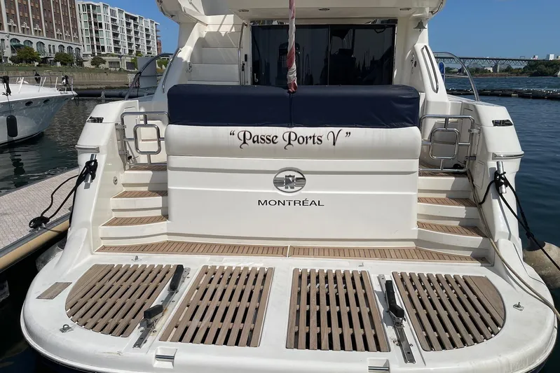 Passe Ports V Yacht Photos Pics 2004 Neptunus 56 Flybridge yacht docked, rear view with "Passe Ports V" and "Montr&eacute;al" text.