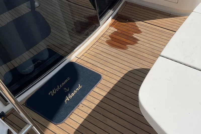 Passe Ports V Yacht Photos Pics Welcome mat on Neptunus 56 Flybridge yacht deck, 2004 model.