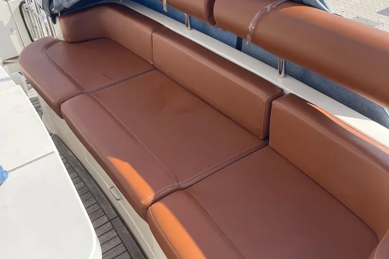 Passe Ports V Yacht Photos Pics Brown leather seating on 2004 Neptunus 56 Flybridge yacht deck.