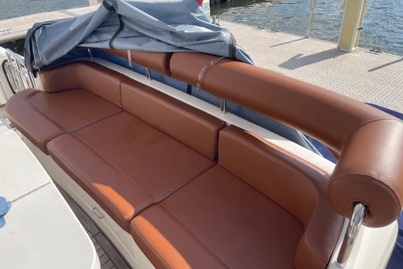 Passe Ports V Yacht Photos Pics Luxurious brown leather seating on 2004 Neptunus 56 Flybridge yacht deck.