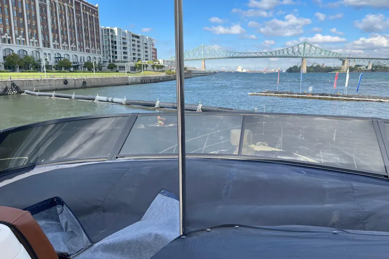 Passe Ports V Yacht Photos Pics 2004 Neptunus 56 Flybridge yacht on a river with cityscape and bridge view.