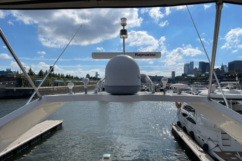 Passe Ports V Yacht Photos Pics 2004 Neptunus 56 Flybridge yacht docked in a marina with city skyline.