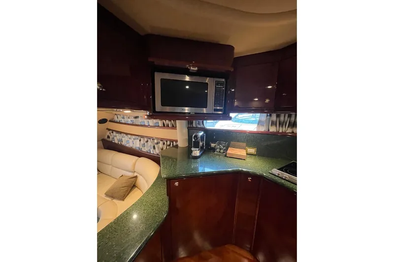 Passe Ports V Yacht Photos Pics Luxurious 2004 Neptunus 56 Flybridge yacht kitchen with modern appliances and elegant design.