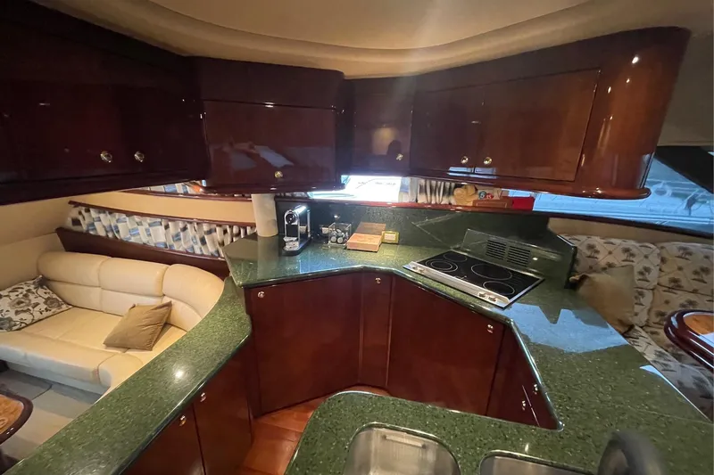 Passe Ports V Yacht Photos Pics Luxurious 2004 Neptunus 56 Flybridge yacht interior with elegant kitchen and seating area.