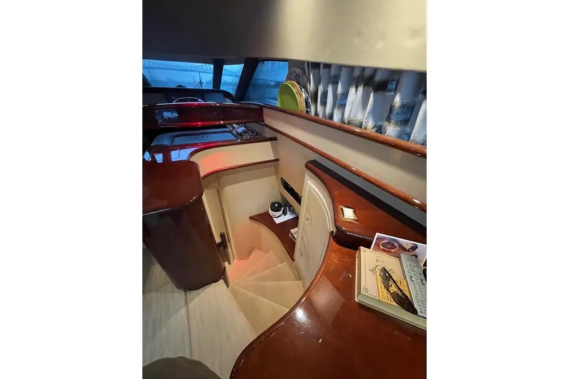 Passe Ports V Yacht Photos Pics Interior of 2004 Neptunus 56 Flybridge yacht with elegant wood finishes and staircase.