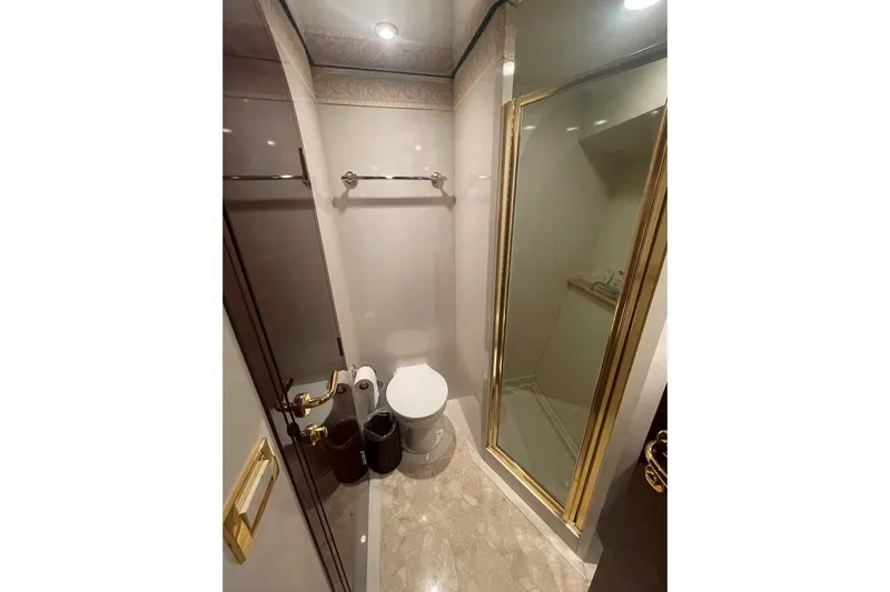Passe Ports V Yacht Photos Pics Luxurious bathroom in 2004 Neptunus 56 Flybridge yacht with gold accents and modern fixtures.
