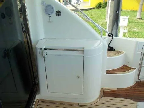 Passe Ports V Yacht Photos Pics 2004 Neptunus 56 Flybridge yacht, featuring sleek stairs and deck area.