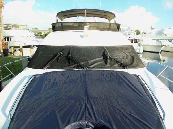 Passe Ports V Yacht Photos Pics 2004 Neptunus 56 Flybridge yacht with covered deck and windows, docked at marina.