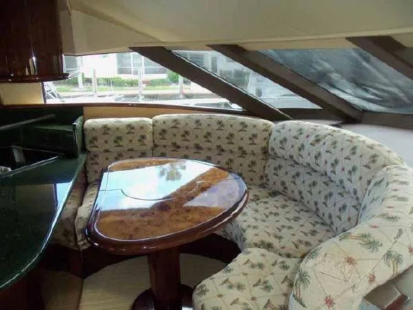 Passe Ports V Yacht Photos Pics Luxurious 2004 Neptunus 56 Flybridge yacht interior with elegant dining area.