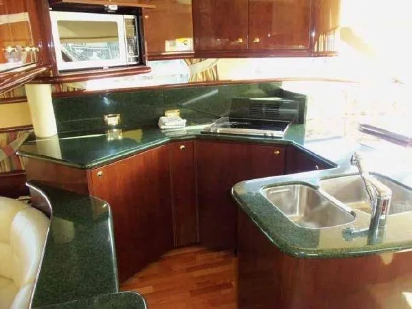 Passe Ports V Yacht Photos Pics Luxurious kitchen interior of 2004 Neptunus 56 Flybridge yacht with green countertops.