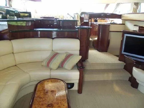 Passe Ports V Yacht Photos Pics Luxurious interior of 2004 Neptunus 56 Flybridge yacht with cream leather seating and wood accents.
