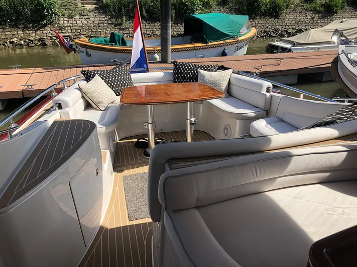  Yacht Photos Pics Luxurious 2012 Zeelander Z44 yacht with elegant seating and wooden table on deck.