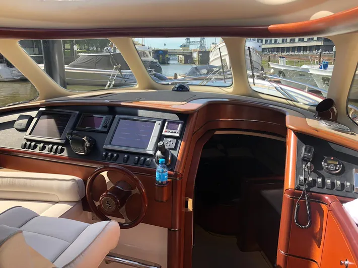  Yacht Photos Pics Luxurious 2012 Zeelander Z44 yacht interior with modern navigation equipment and elegant wood finish.