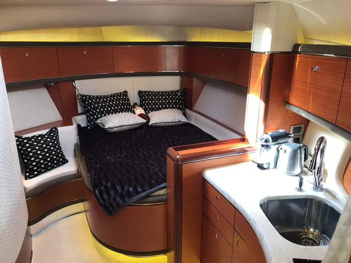  Yacht Photos Pics Luxurious interior of 2012 Zeelander Z44 yacht with cozy bed and kitchenette.