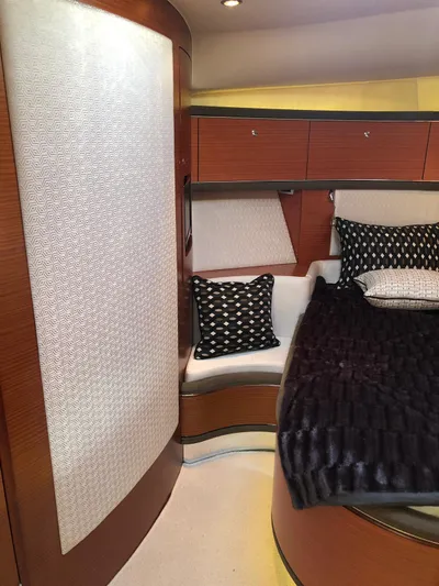  Yacht Photos Pics Luxurious interior of 2012 Zeelander Z44 yacht with elegant wood paneling and plush bedding.