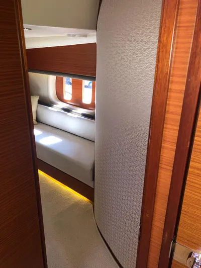  Yacht Photos Pics Interior view of 2012 Zeelander Z44 yacht cabin with wooden finishes and cozy seating.