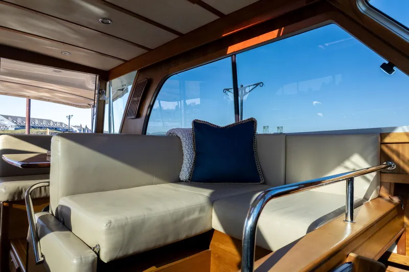 Jackson Yacht Photos Pics Luxurious interior of 2013 Sabre 38 Salon Express yacht with plush seating and blue cushion.