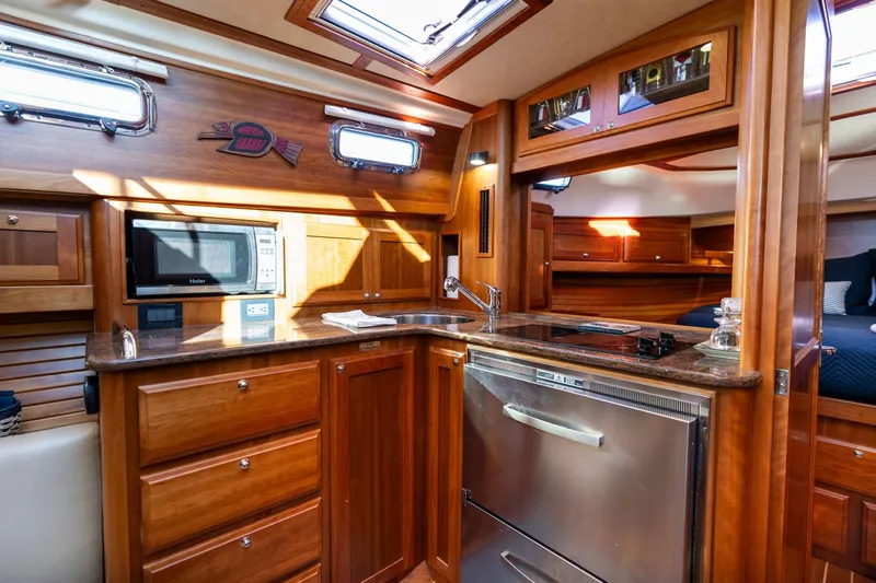 Jackson Yacht Photos Pics Luxurious 2013 Sabre 38 Salon Express yacht interior with wooden cabinetry and modern kitchen amenities.