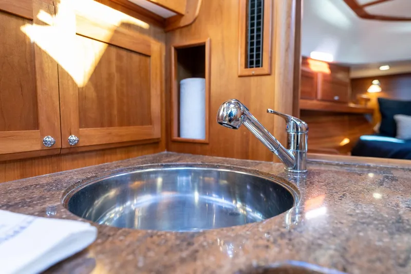 Jackson Yacht Photos Pics 2013 Sabre 38 Salon Express yacht interior with polished sink and wooden cabinetry.