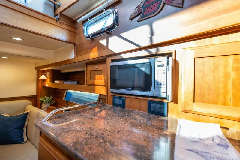 Jackson Yacht Photos Pics 2013 Sabre 38 Salon Express interior with microwave, wooden cabinetry, and cozy seating area.