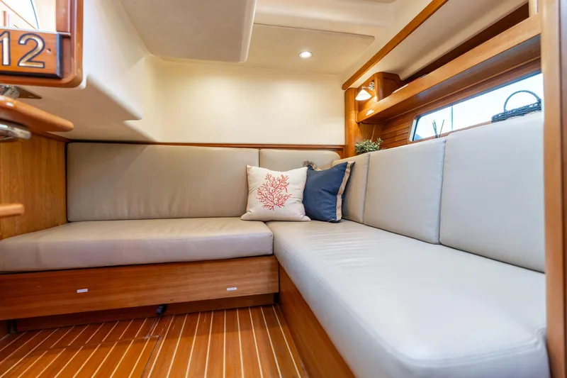 Jackson Yacht Photos Pics 2013 Sabre 38 Salon Express interior with cozy seating and decorative pillows.