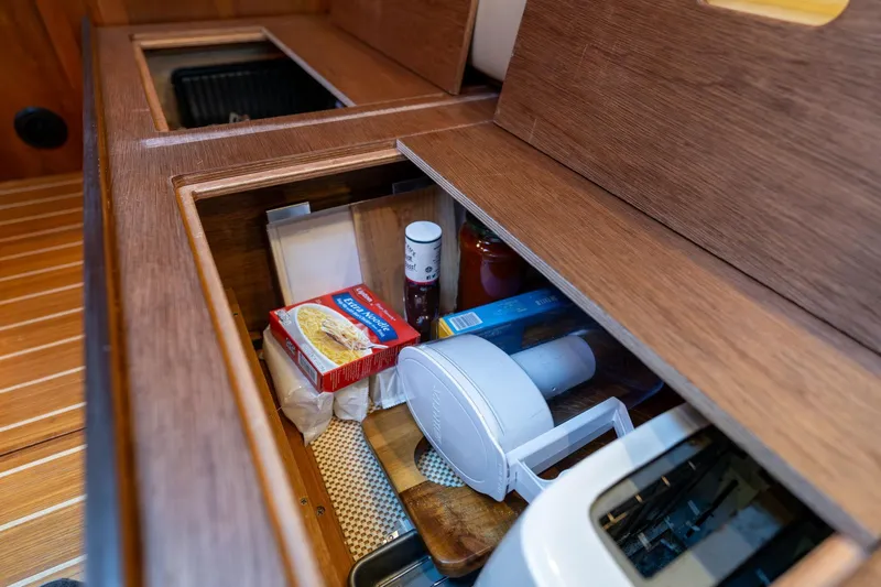 Jackson Yacht Photos Pics Storage compartment in 2013 Sabre 38 Salon Express yacht kitchen with various food items.