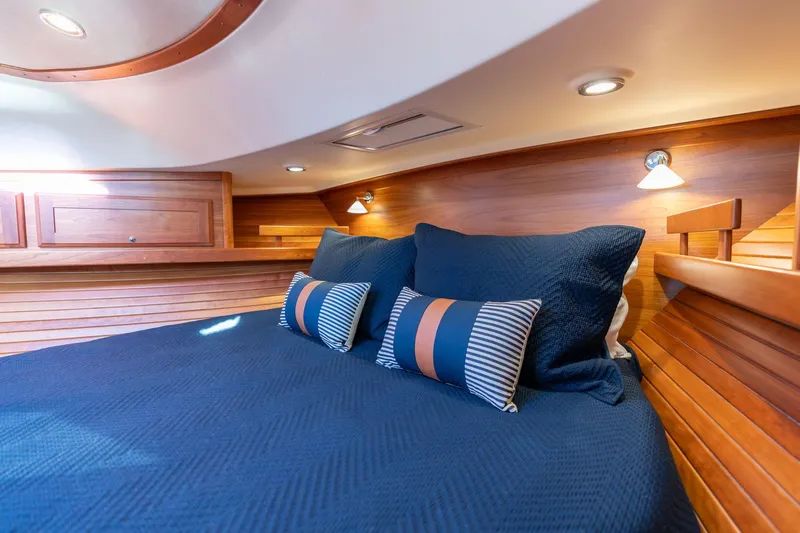 Jackson Yacht Photos Pics Luxurious cabin interior of 2013 Sabre 38 Salon Express with blue bedding and wooden accents.